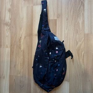 Sling bag crossbody bag with galaxy and stars pattern. Features  zipper closure.